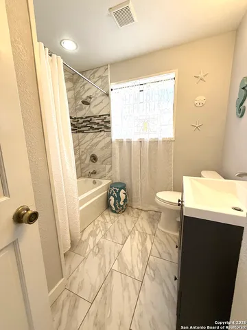 a view of a bathroom with a tub and shower