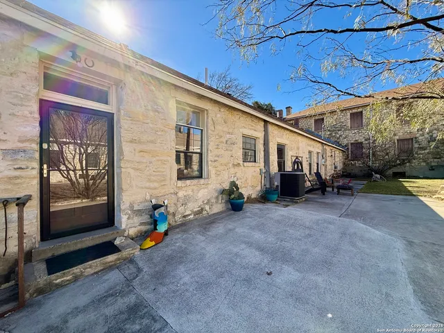 a kitchen with white cabinets and appliances