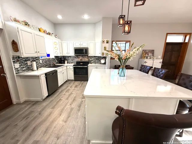 a dining room with furniture a fireplace and wooden floor