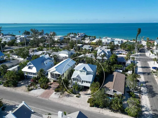 an aerial view of a house with a ocean view