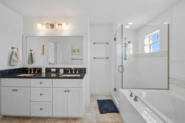 a bedroom with a bed and a lamp on table