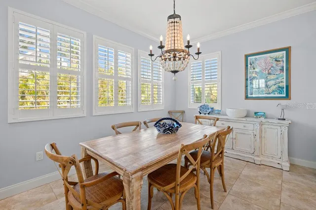 a view of a dining room with furniture and a chandelier