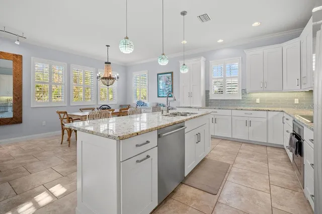 a kitchen with kitchen island granite countertop wooden cabinets and a granite counter tops