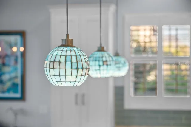 a kitchen with a stove a sink a dining table and chairs