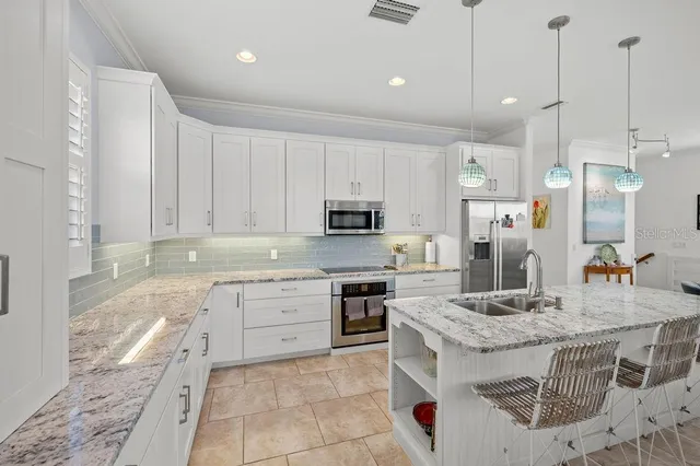 a view of kitchen with granite countertop window and sink