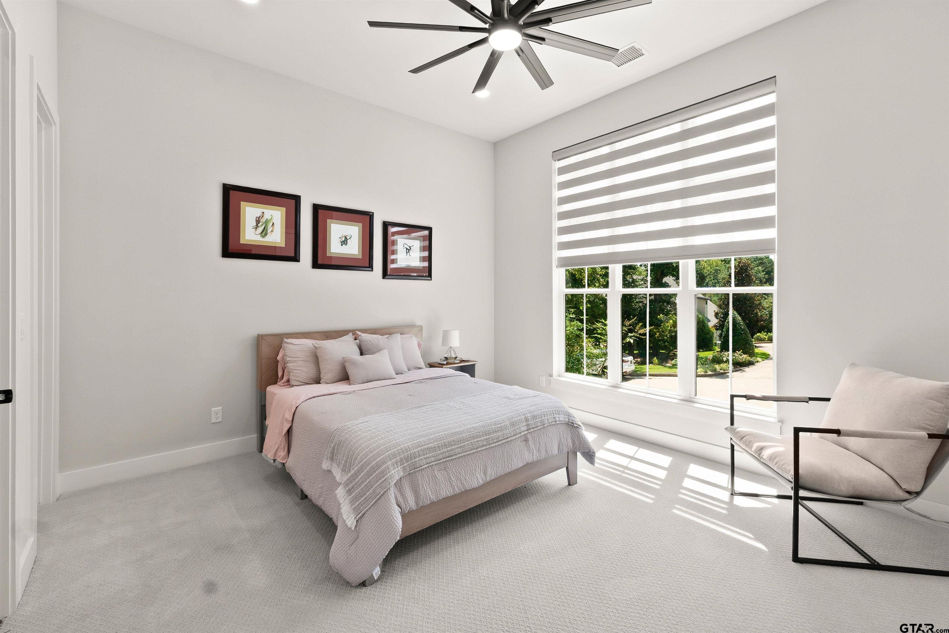 2895 Stewart Way Tyler, TX 75709 - Photo 16 of 44 a spacious bedroom with a bed and a large window