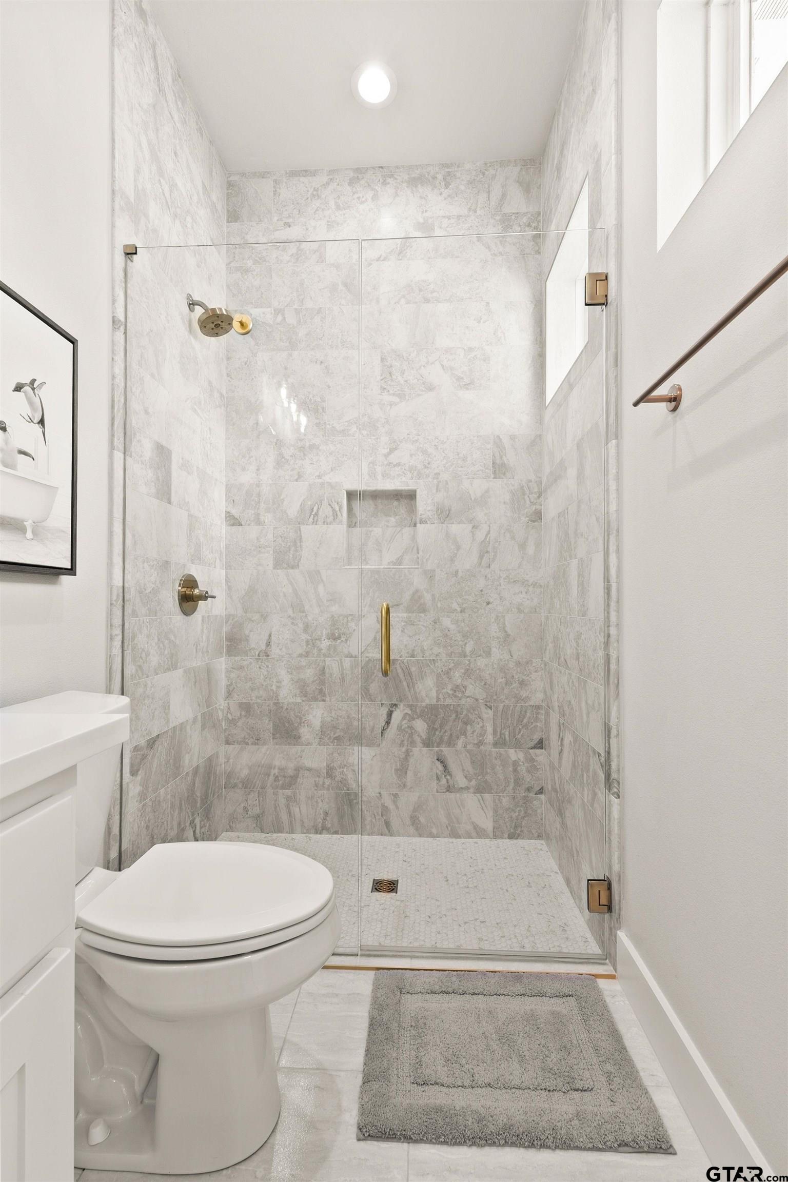 2895 Stewart Way Tyler, TX 75709 - Photo 18 of 44 a bathroom with a toilet and shower