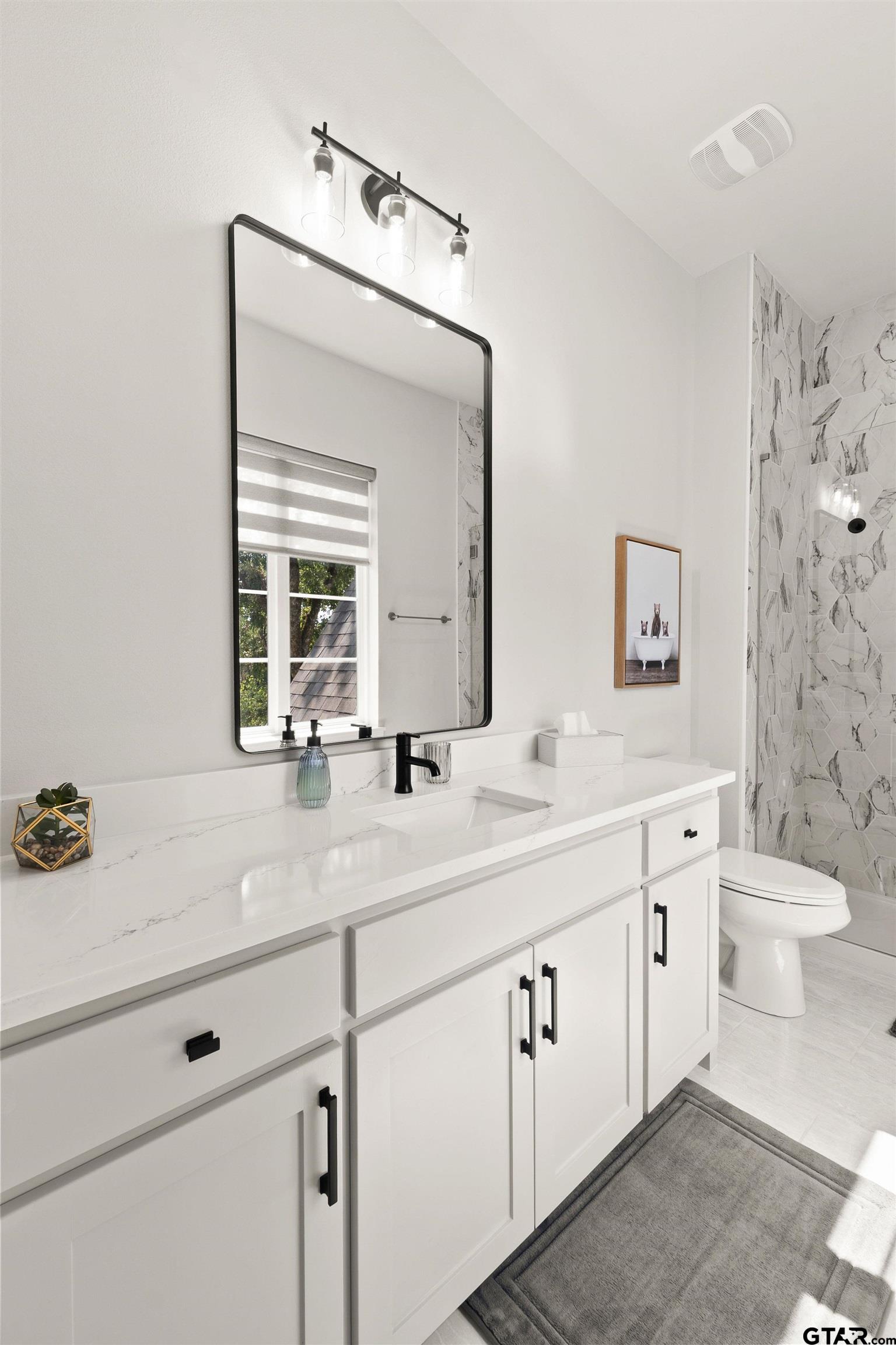 2895 Stewart Way Tyler, TX 75709 - Photo 22 of 44 a bathroom with a double vanity sink toilet and a mirror