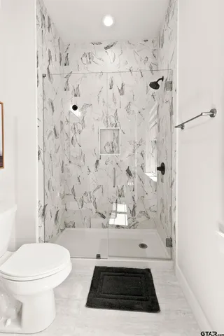 a bathroom with a toilet and shower