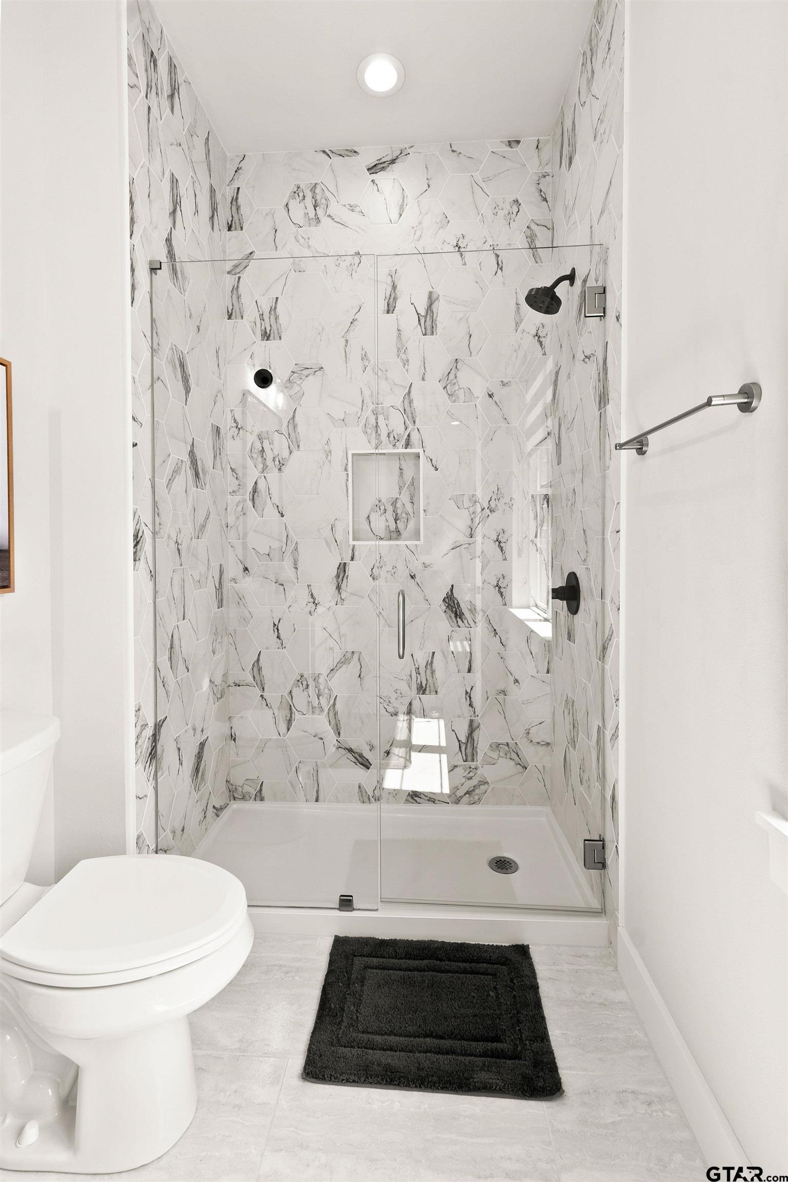 2895 Stewart Way Tyler, TX 75709 - Photo 23 of 44 a bathroom with a toilet and shower