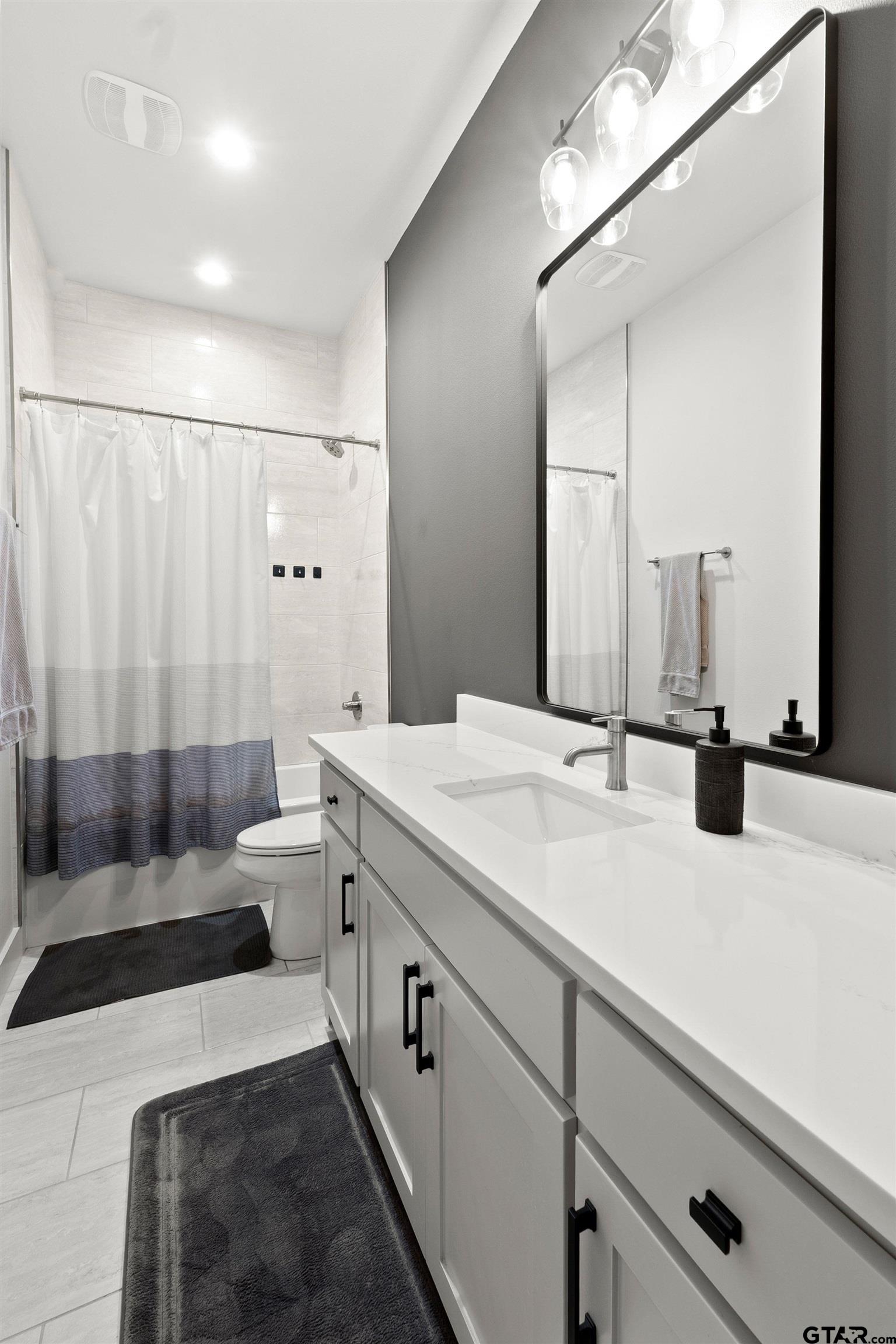 2895 Stewart Way Tyler, TX 75709 - Photo 28 of 44 a bathroom with a double vanity sink toilet and shower