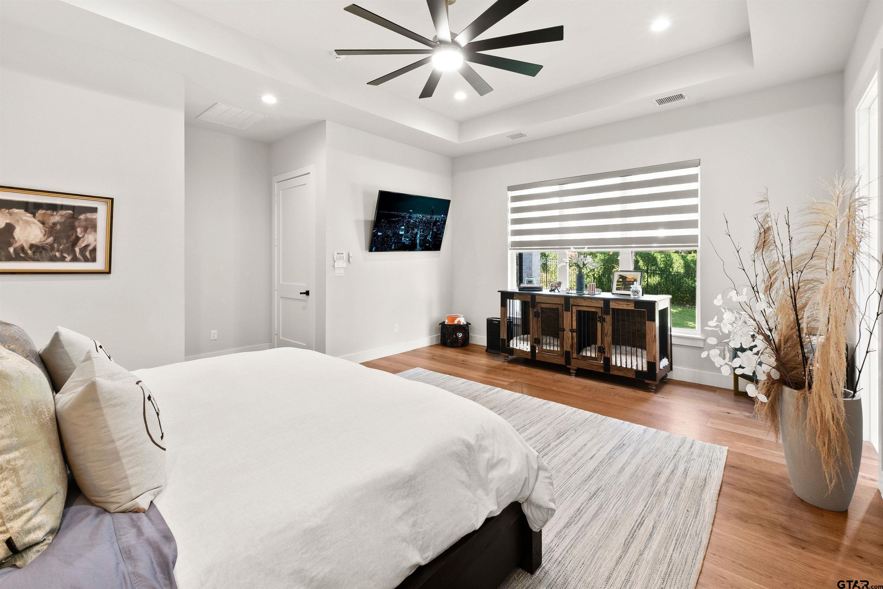 2895 Stewart Way Tyler, TX 75709 - Photo 32 of 44 a bedroom with a bed and wooden floor