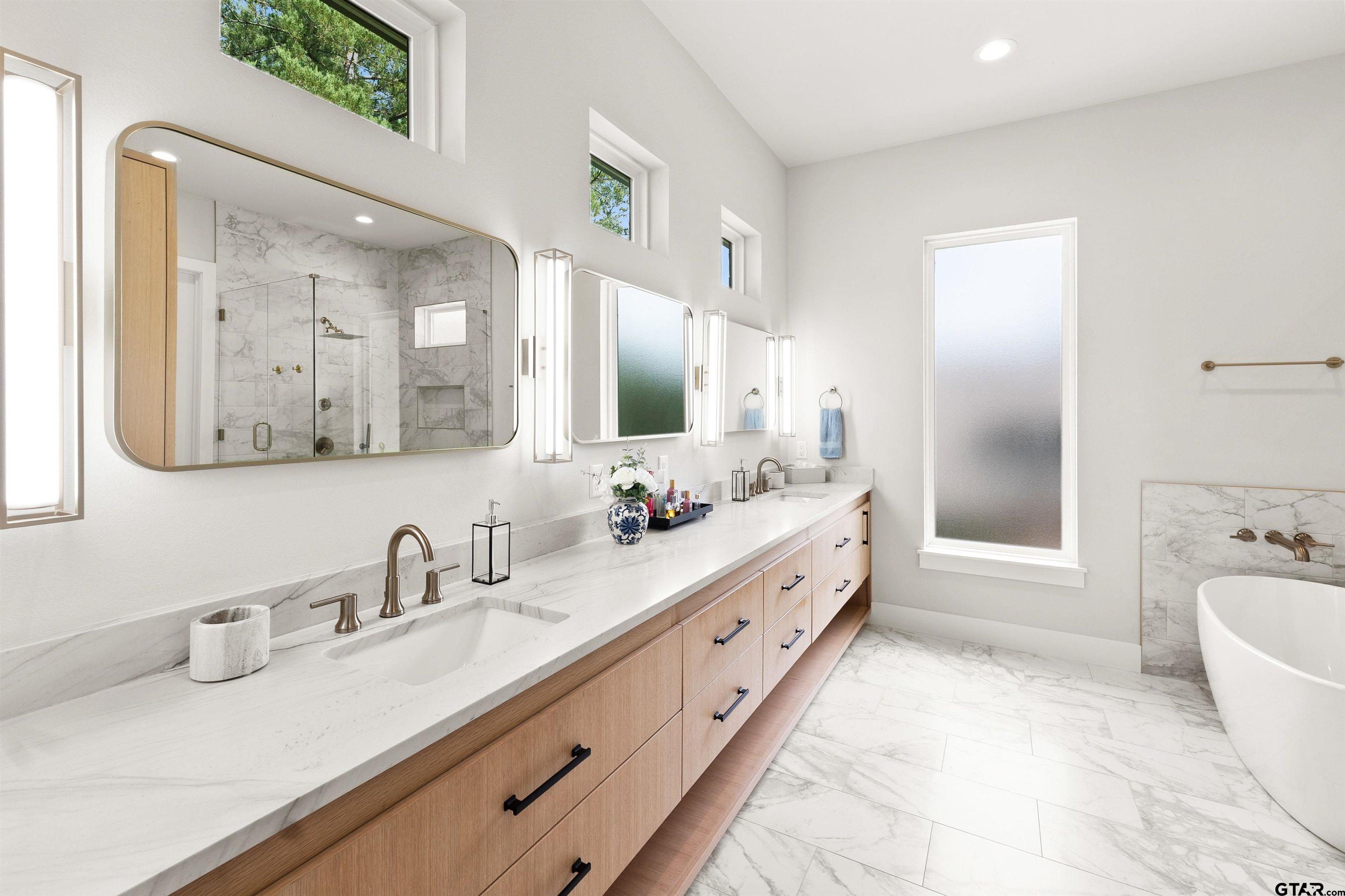 2895 Stewart Way Tyler, TX 75709 - Photo 33 of 44 a spacious bathroom with a double vanity sink mirror and bathtub