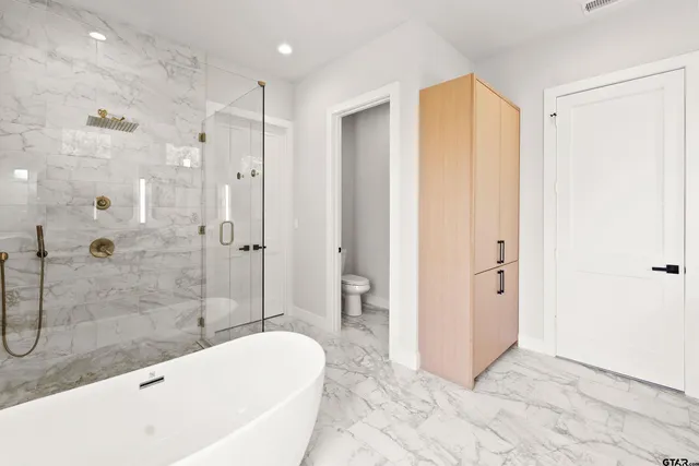 a bathroom with a bathtub and a shower