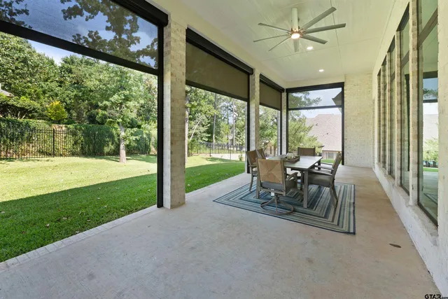 a view of a porch with chairs and backyard
