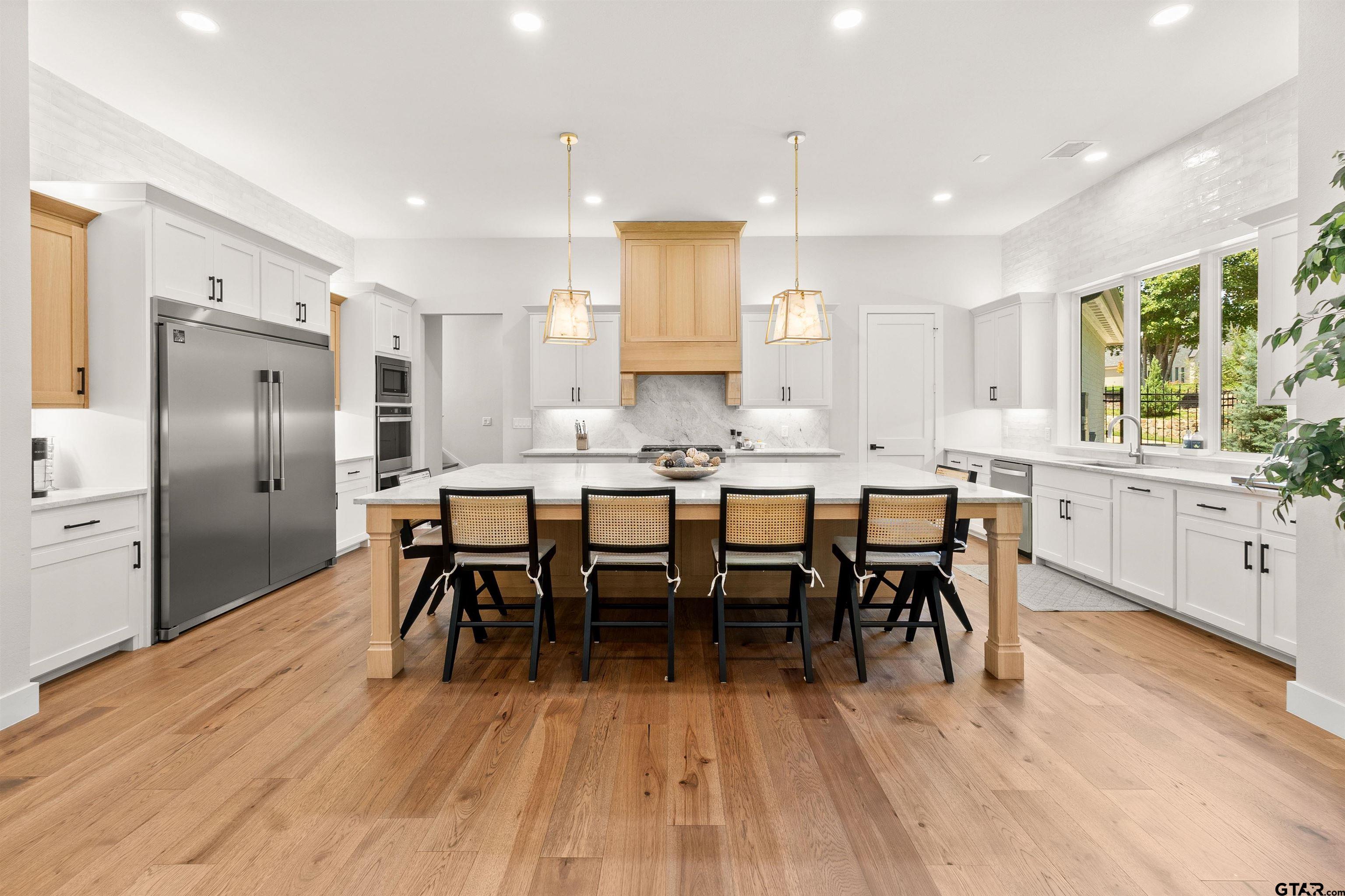 2895 Stewart Way Tyler, TX 75709 - Photo 8 of 44 a large kitchen with a table and chairs