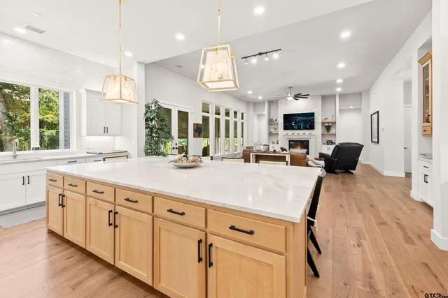 a kitchen with counter top space a sink stainless steel appliances and windows