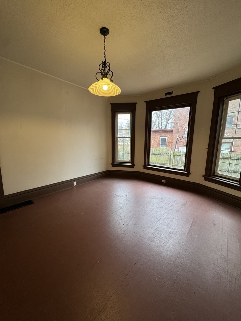 809 West 4th Street, Unit 1 Sterling, IL 61081 - Photo 2 of 4 an empty room with a empty space and windows