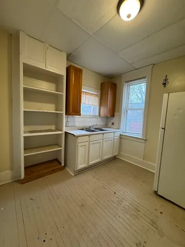 a view of a kitchen with a sink dishwasher and a refrigerator
