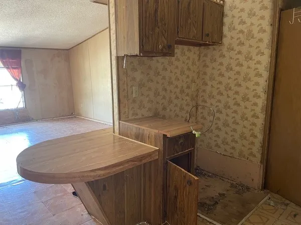 a bathroom with a granite countertop sink a toilet and shower