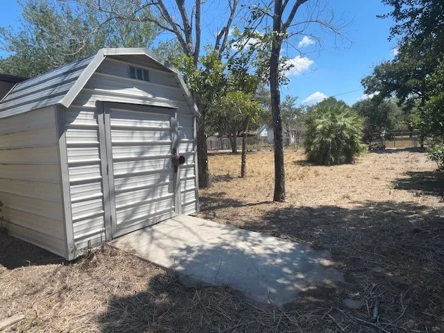 a view of a backyard with a tree