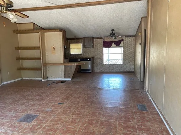 an empty room with windows and entrance