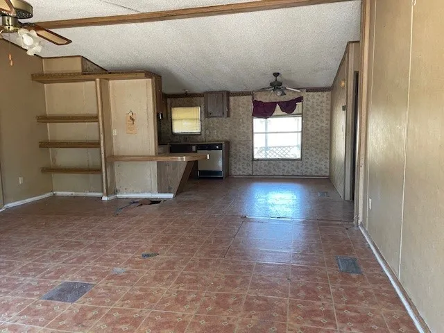 an empty room with windows and entrance