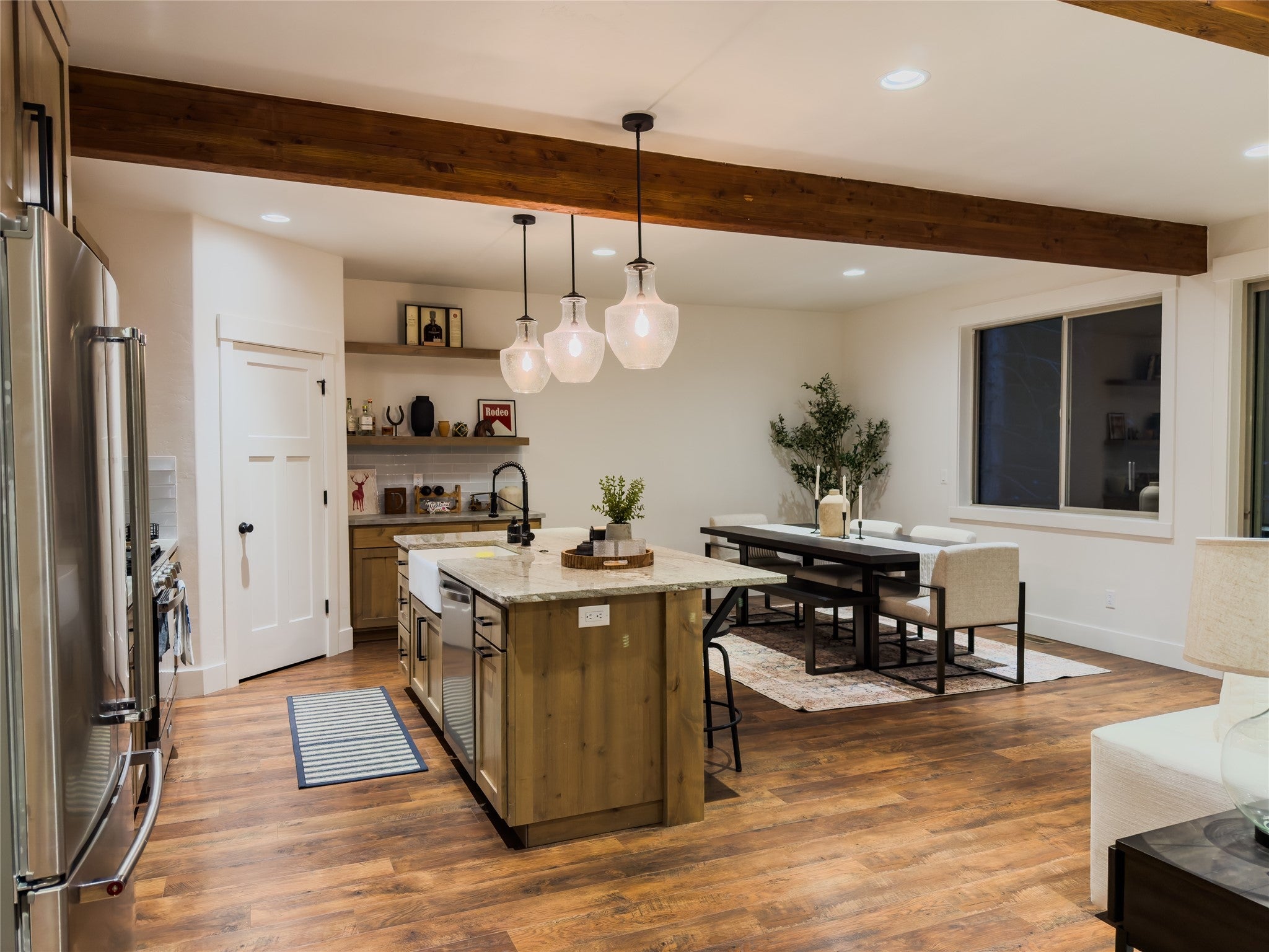 717 Icehouse Road Whitefish, MT 59937 - Photo 7 of 31 Kitchen featuring light stone counters, pendant lighting, appliances with stainless steel finishes, dark wood-style flooring, and recessed lighting