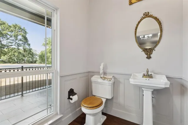 a bathroom with a toilet sink and mirror