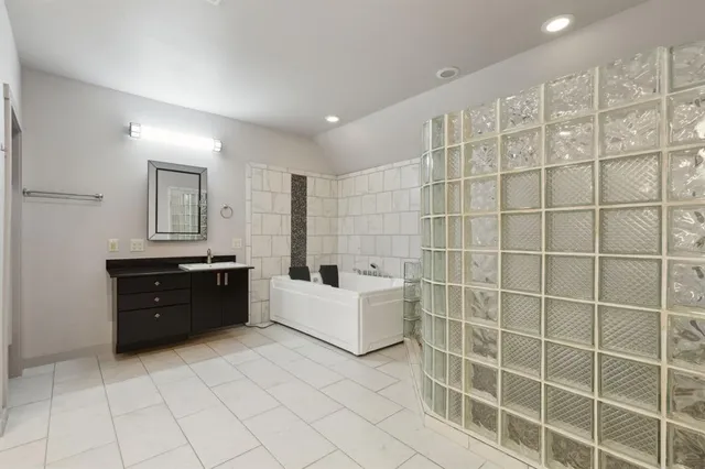 a large bathroom with a bathtub and a sink