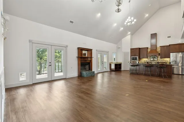a view of a kitchen with furniture and wooden floor