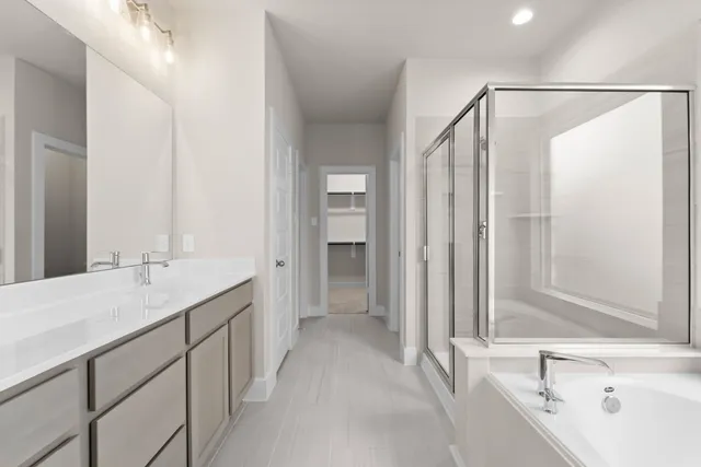 a bathroom with a double vanity sink mirror and shower