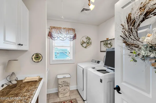 a spacious bedroom with a bed and a chandelier