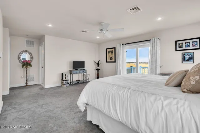 a bathroom with a granite countertop sink a mirror and shower