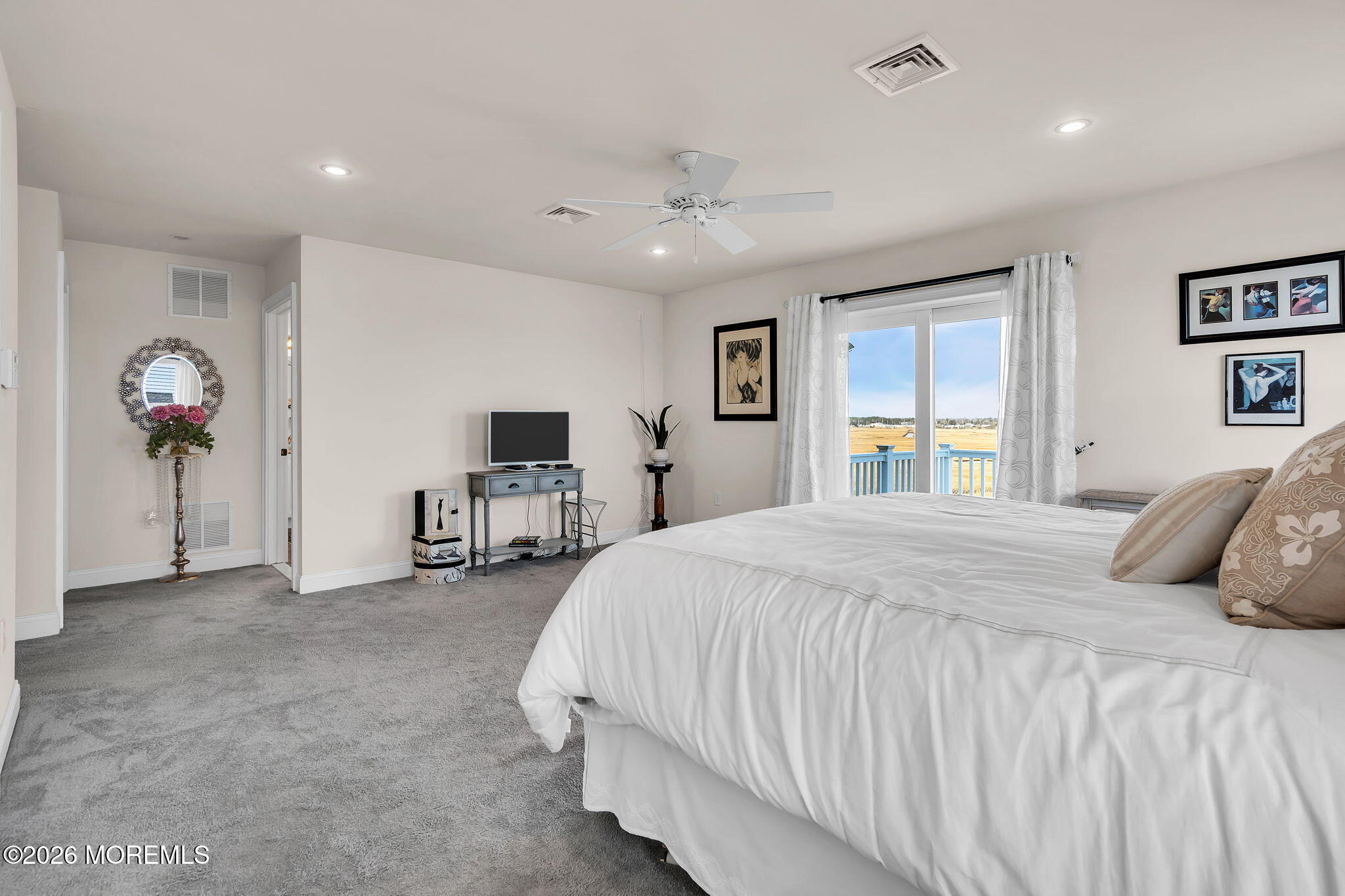 385 Kingfisher Road Tuckerton, NJ 08087 - Photo 24 of 58 a bedroom with a bed and a chandelier