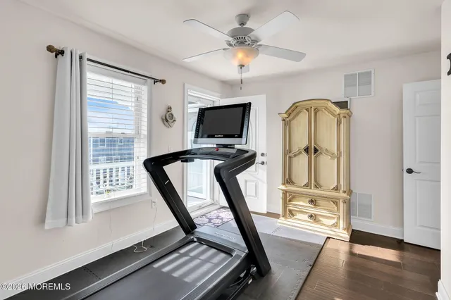 a view of a room with wooden floor and windows