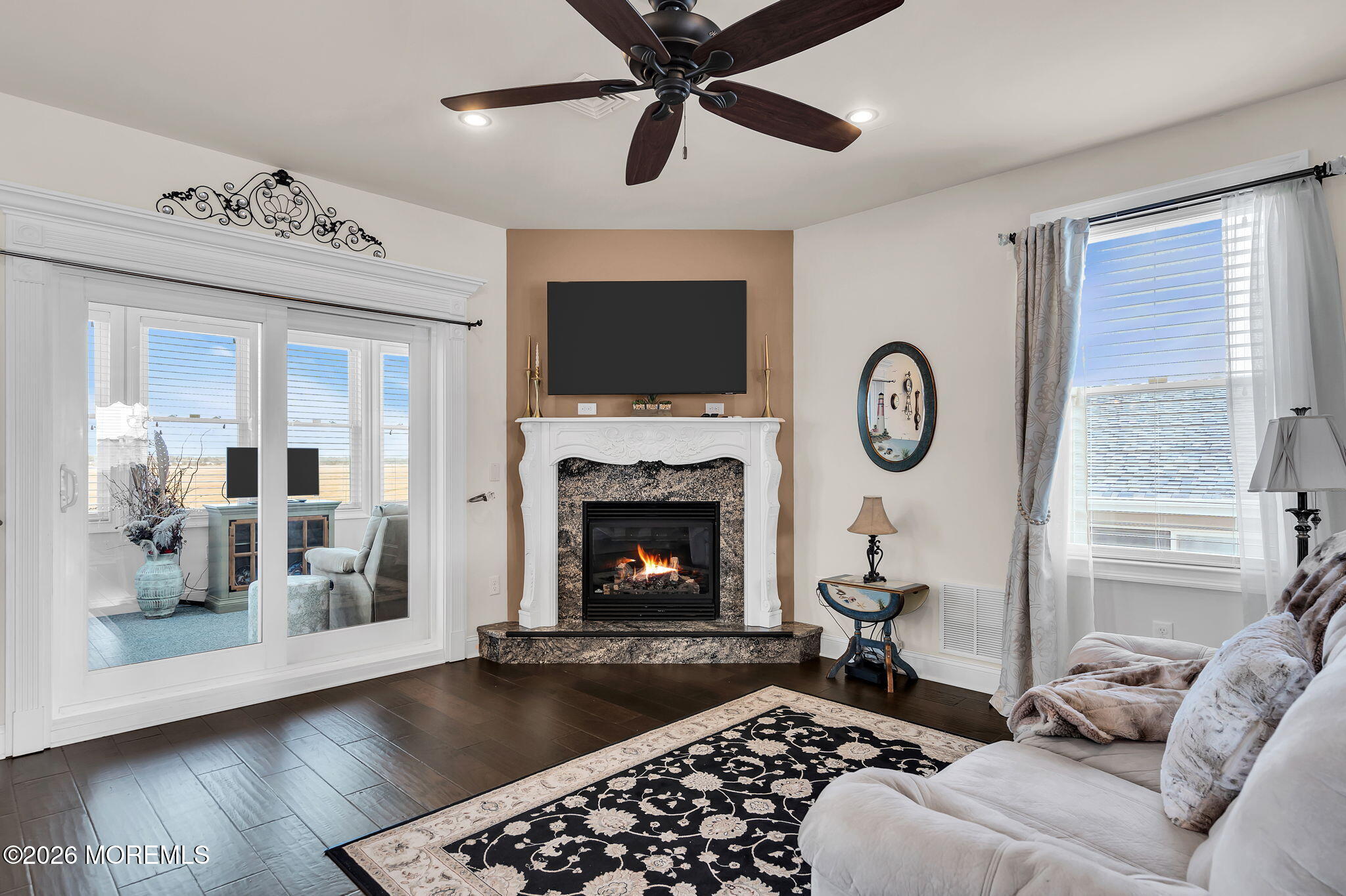 385 Kingfisher Road Tuckerton, NJ 08087 - Photo 8 of 58 a living room with furniture a flat screen tv and a fireplace