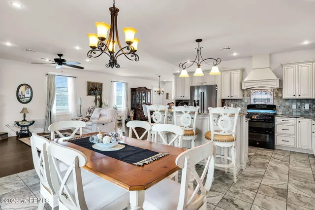a view of a dining room kitchen and a chandelier