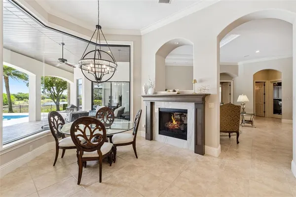 a dining room with furniture a chandelier and a rug