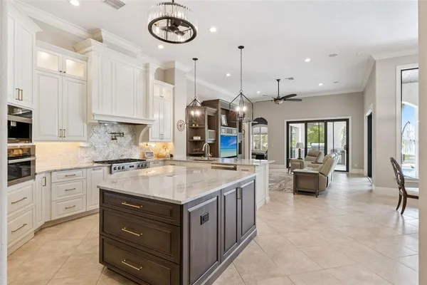 a kitchen with stainless steel appliances granite countertop a stove and a sink