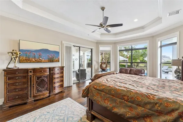 a bedroom with a bed a couch and a chandelier