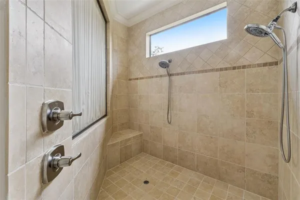 a bathroom with a granite countertop toilet sink and mirror