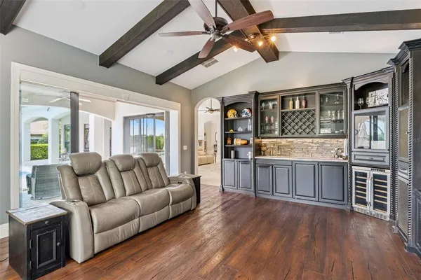 a living room with patio furniture and a large window