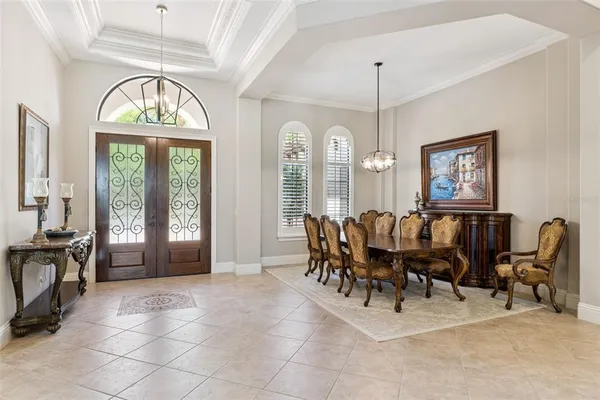 a dining room with furniture a chandelier and window