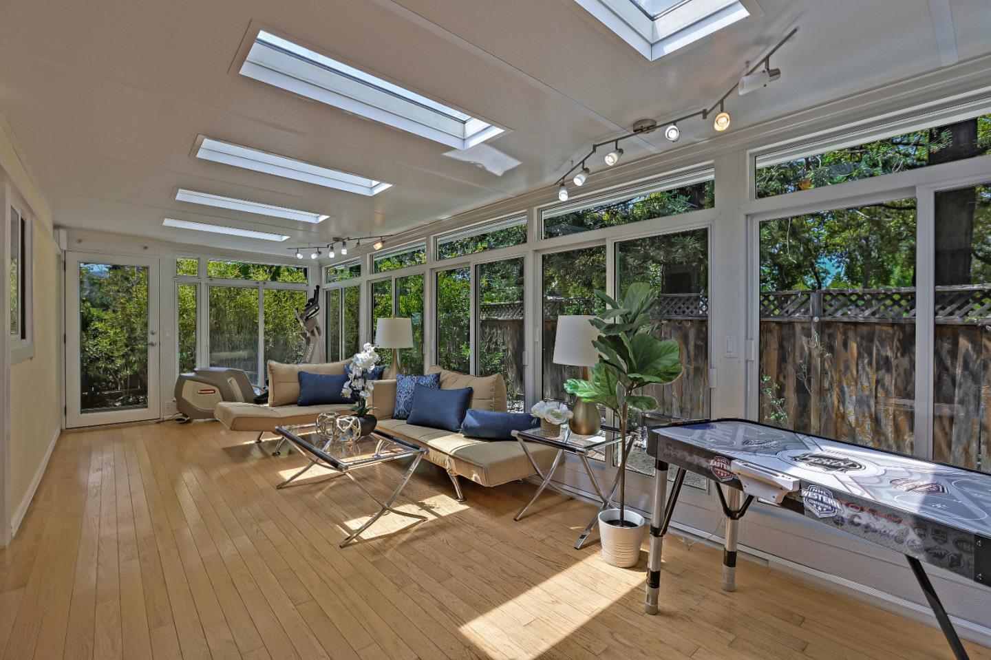 7949 Belknap Drive Cupertino, CA 95014 - Photo 5 of 8 a living room with furniture and large windows