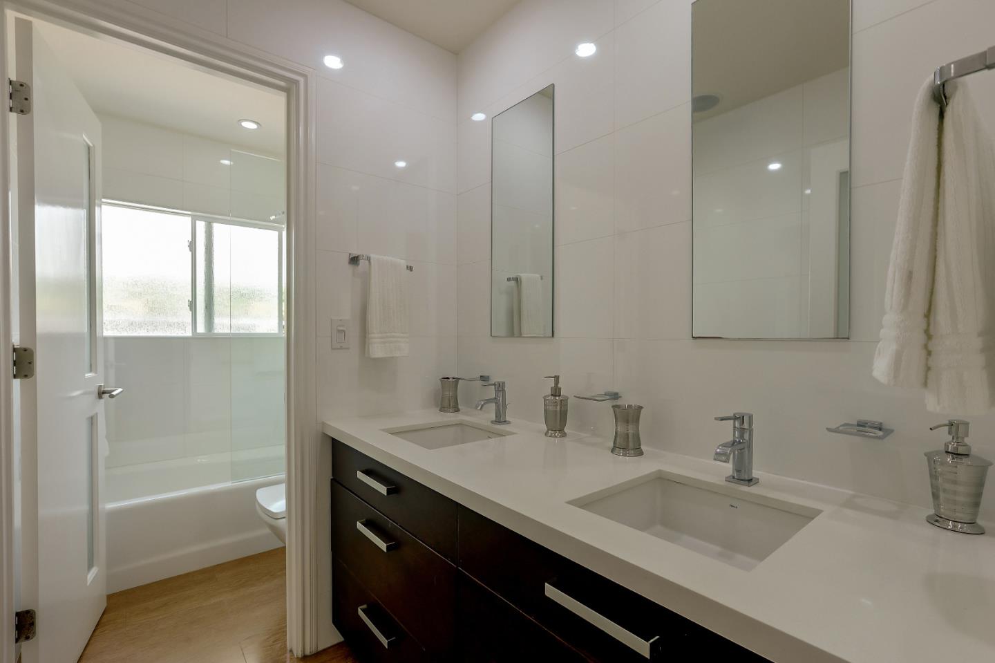 7949 Belknap Drive Cupertino, CA 95014 - Photo 7 of 8 a bathroom with a sink double vanity granite tub and a mirror