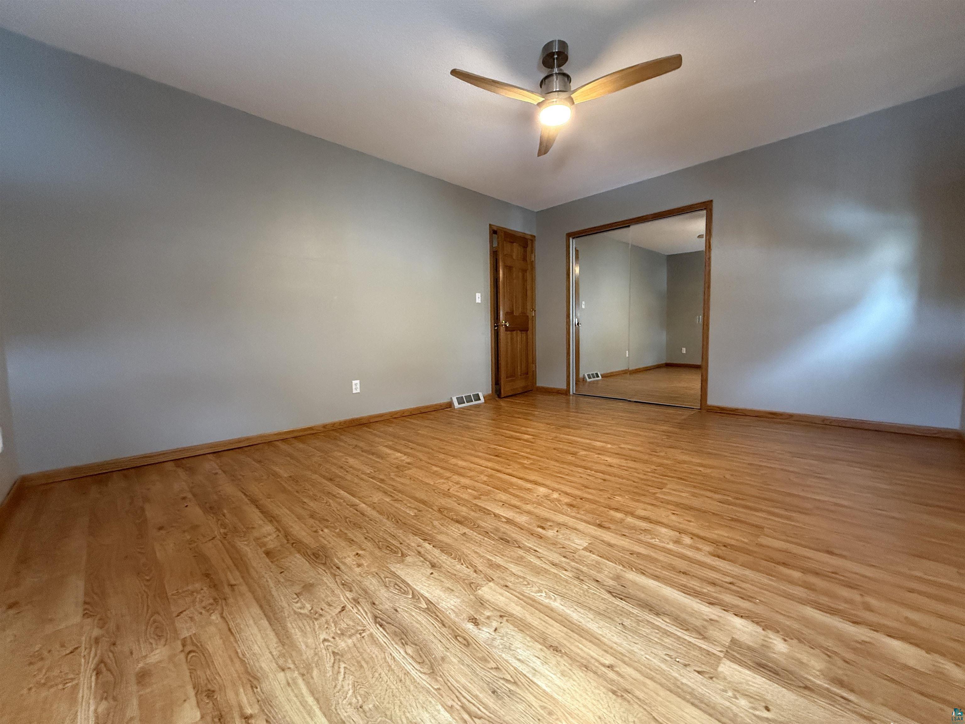 1321 South 13th Street Virginia, MN 55792 - Photo 18 of 33 Unfurnished bedroom featuring a closet, light wood-style floors, and ceiling fan