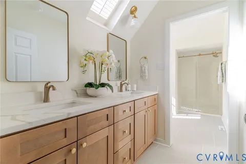 a bathroom with a double vanity sink and a mirror