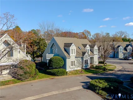 a front view of a house with a garden and mountain view