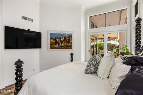 a bedroom with a bed and a flat screen tv